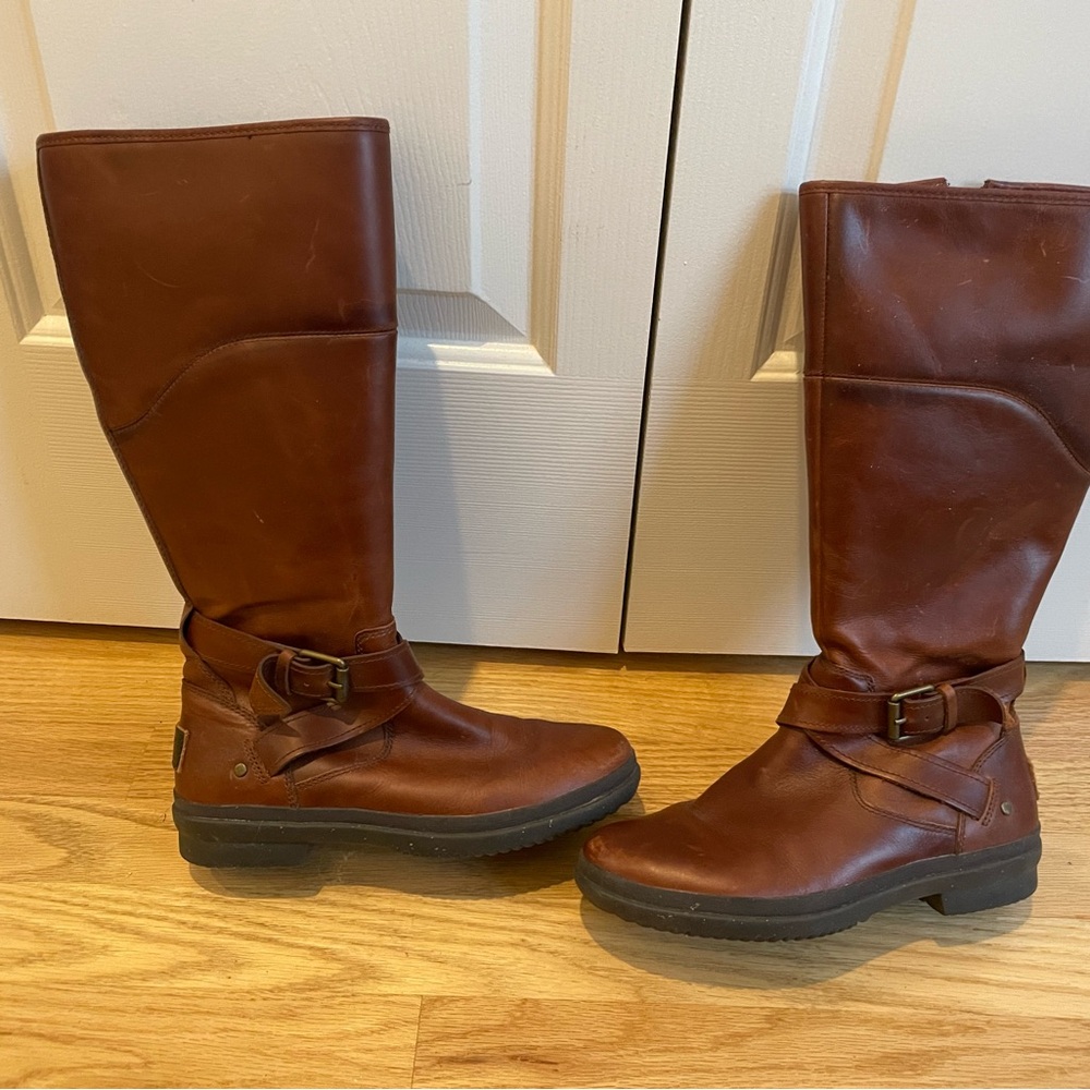 Brown tall leather ugh boots with fuzzy sheep interior.